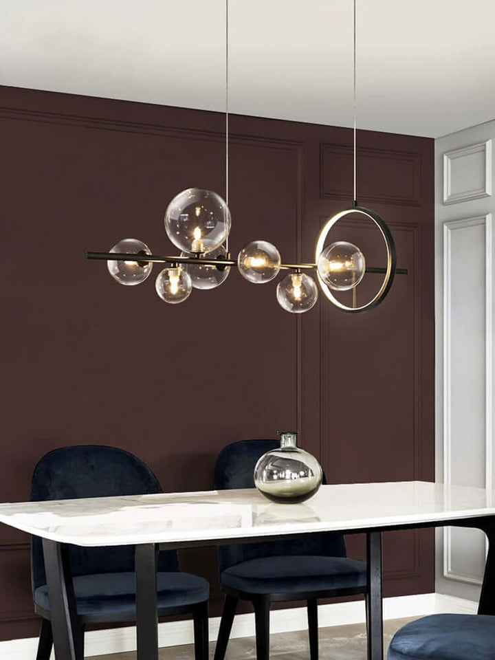 Glasboble pendellampe over et spisebord