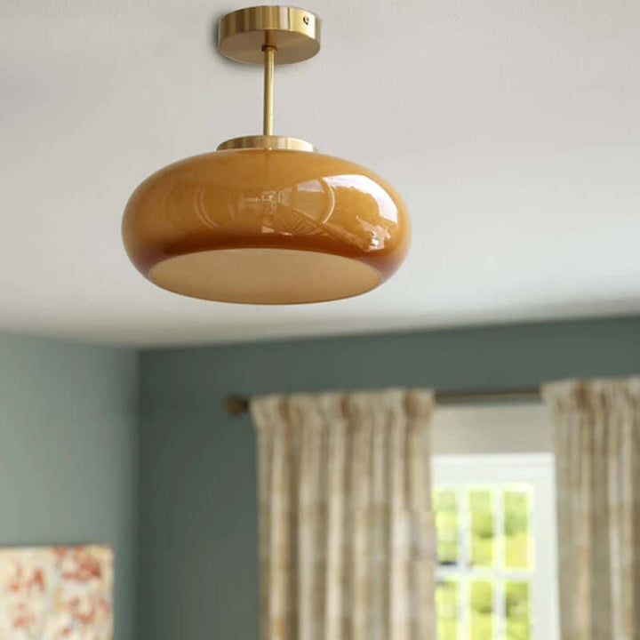 Vintage loftslampe med orange glaskuppel og kobberstel
