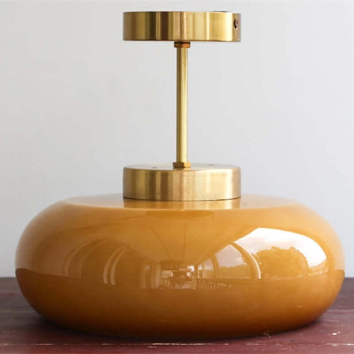 Vintage loftslampe med orange glaskuppel og kobberstel