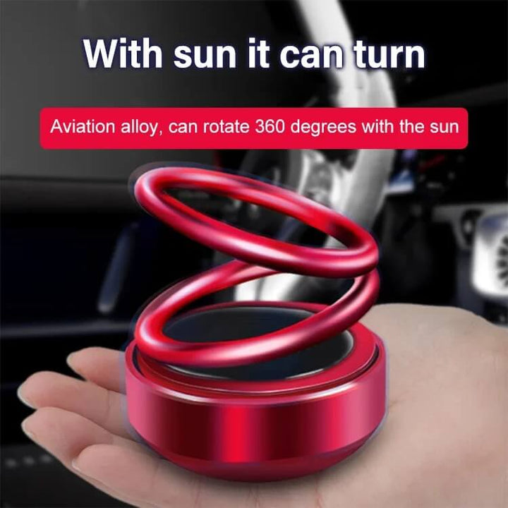 Aurinkoenergialla toimiva kaksoisrenkainen aromaterapiakoriste autoon, punainen metallinen design, raikas tuoksu.