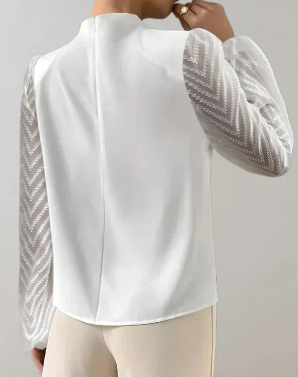 Elegant dame let hvid top med rund hals og stilfuldt snit.