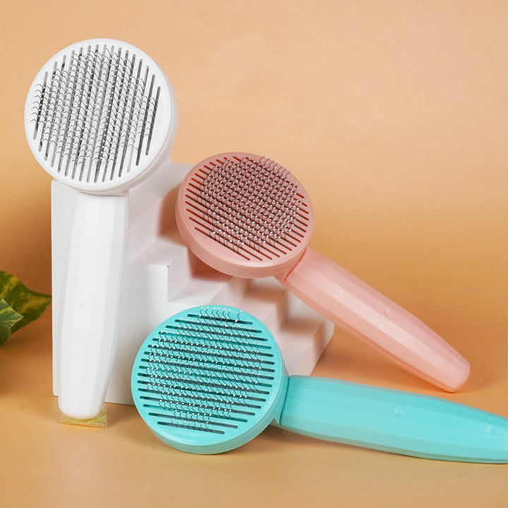 Ergonomisk kæledyrskost i hvid, pink og grøn, lavet af rustfrit stål og teknisk plast.