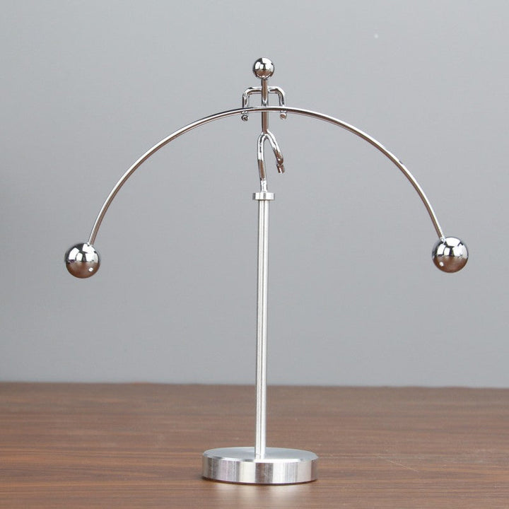 Moderne sølvfarvet metaldekoration med balance mekanisme, elegant tilføjelse til skrivebord eller soveværelse.