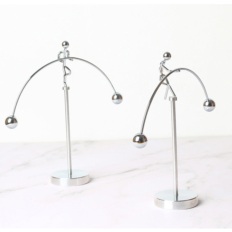 Moderne sølvfarvet metaldekoration med balance mekanisme, elegant tilføjelse til skrivebord eller soveværelse.