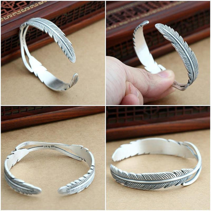 Sølvbelagt dame armbånd med fjerdesign, let og elegant tilbehør der symboliserer beskyttelse og frihed.