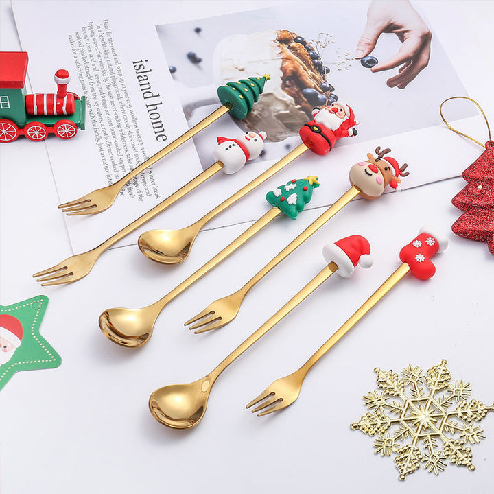 Julebestik sæt i rustfrit stål med dekorativ julemandfigur, guld og sølv farve, perfekt til fest