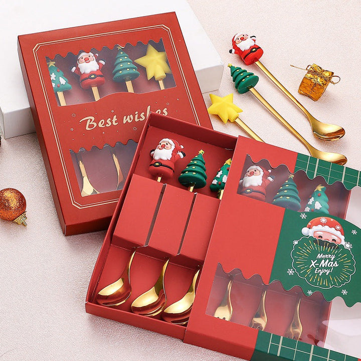 Julebestik sæt i rustfrit stål med dekorativ julemandfigur, guld og sølv farve, perfekt til fest