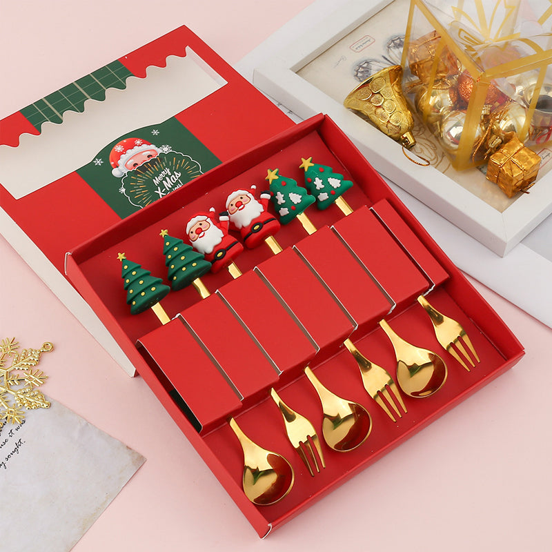 Julebestik sæt i rustfrit stål med dekorativ julemandfigur, guld og sølv farve, perfekt til fest
