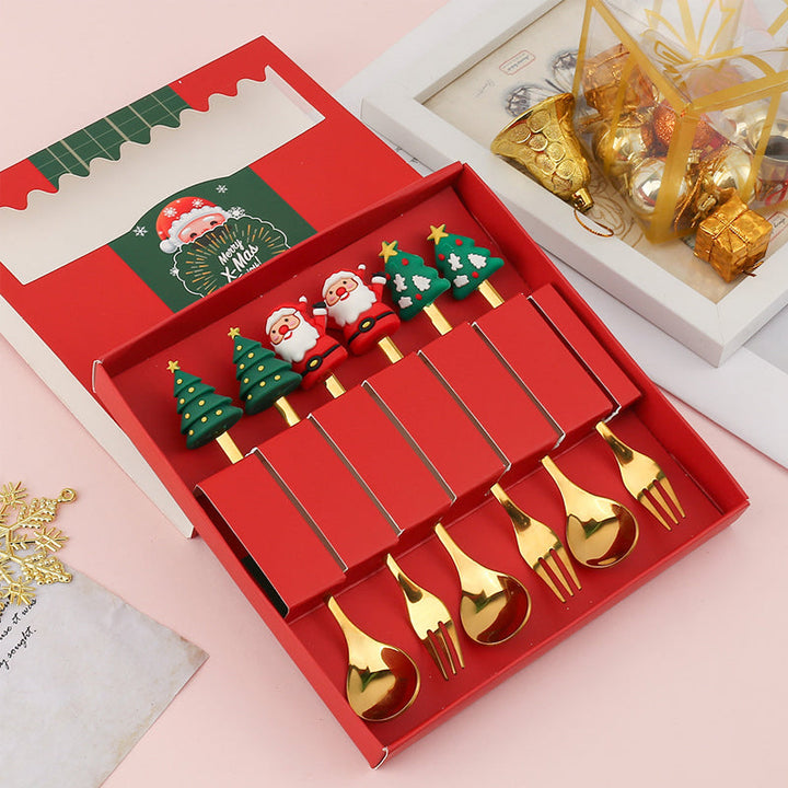 Julebestik sæt i rustfrit stål med dekorativ julemandfigur, guld og sølv farve, perfekt til fest