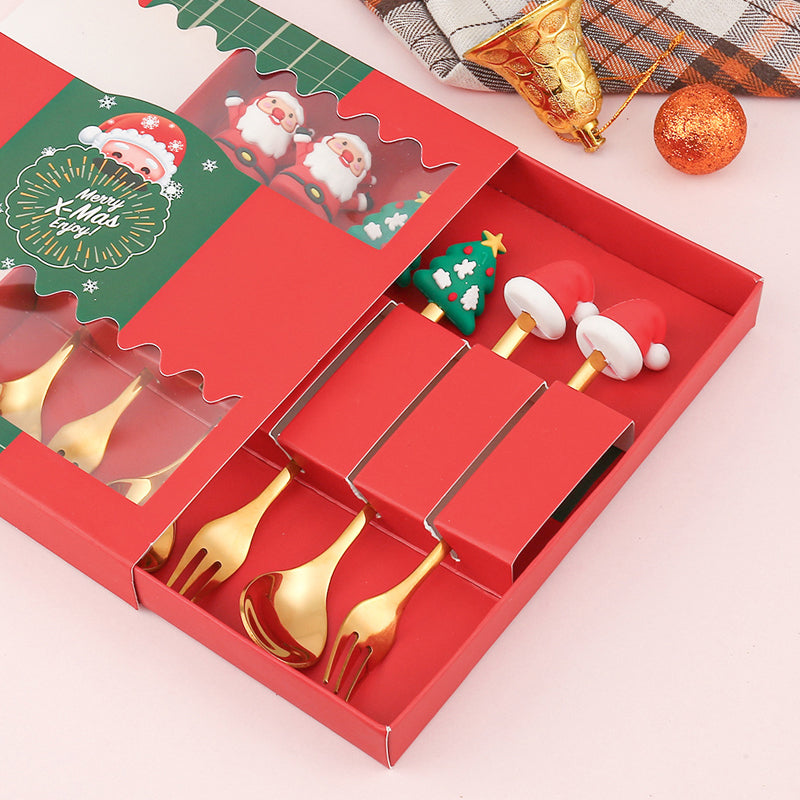 Julebestik sæt i rustfrit stål med dekorativ julemandfigur, guld og sølv farve, perfekt til fest