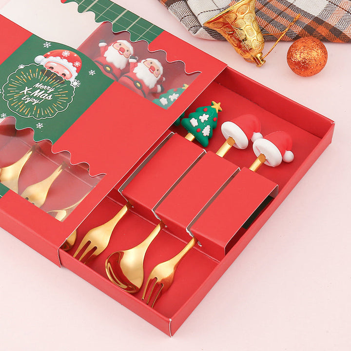 Julebestik sæt i rustfrit stål med dekorativ julemandfigur, guld og sølv farve, perfekt til fest