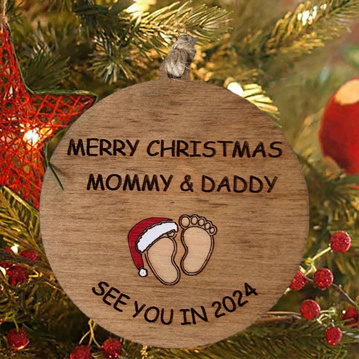 Julepynt til vordende forældre, indgraveret med teksten 'Merry Christmas Mommy and Daddy See You in 2024', bøgetræ