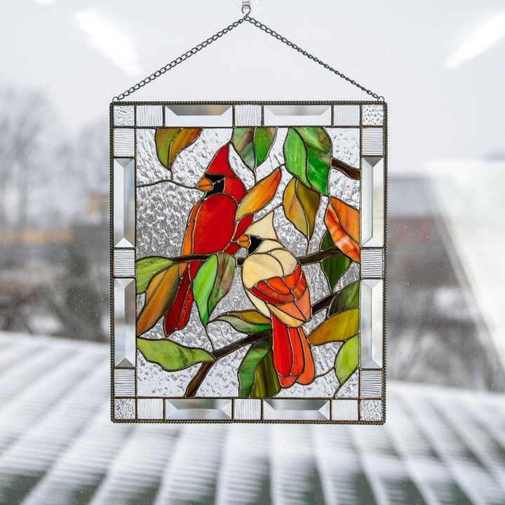 Kardinaalilintu akryylikoriste ikkunaan, värikäs ja kirkas, luo rauhoittavaa kauneutta valon heijastuessa.