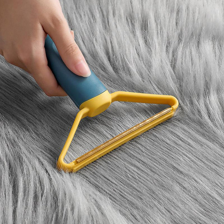 Let, flerfarvet dobbelsidet fnugfjerner, ergonomisk design, egnet til uld, bomuld og sarte materialer.