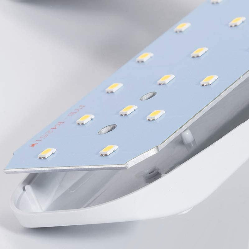 Sammenklappelig LED-lampe, køligt dagslys, justerbar, energieffektiv; plastkonstruktion til indendørs brug.