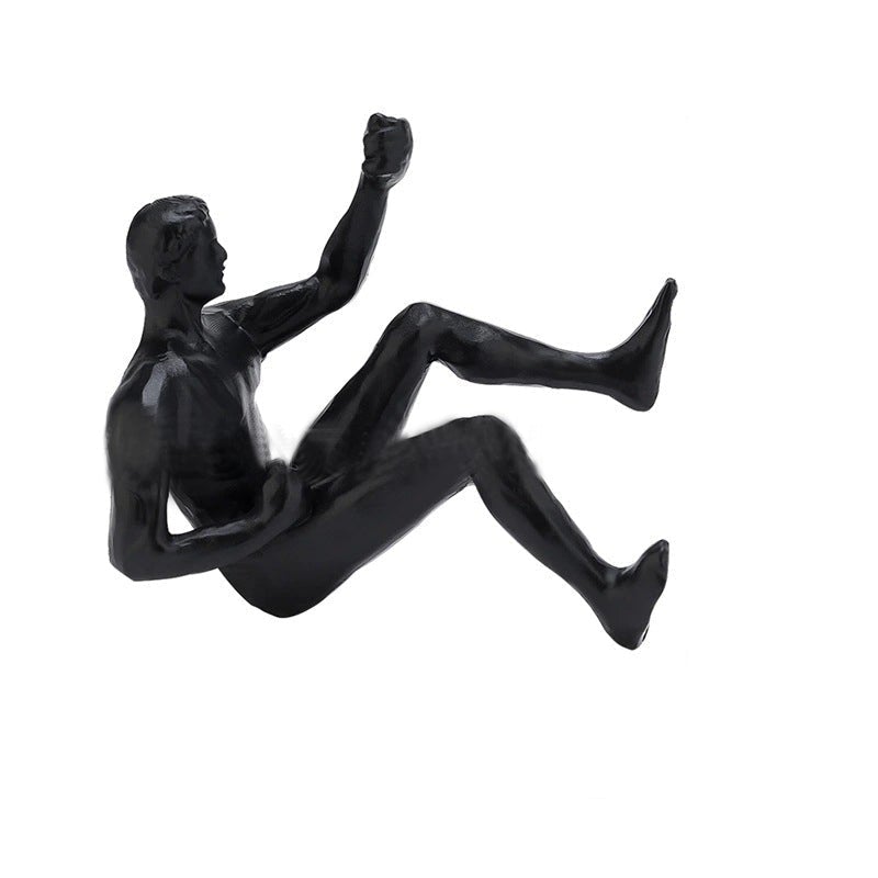 3D vægklatrefigur, sort figur der klatrer på en lodret overflade, moderne boligdekoration.
