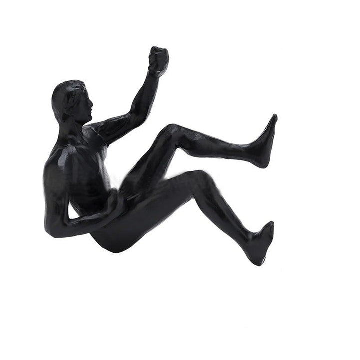 3D vægklatrefigur, sort figur der klatrer på en lodret overflade, moderne boligdekoration.