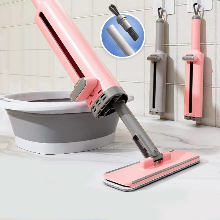 Kompakt selvpressende minimop i pink: let og praktisk til hjemmet og rejser.