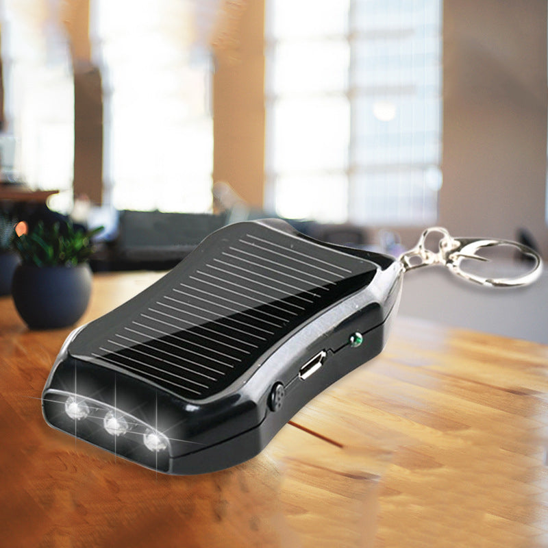 Kompakt hvid og sort mini powerbank nøglering, stilfuldt telefontilbehør, lommevenlig kraftfuld oplader.