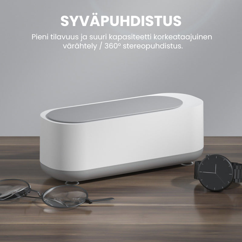 Kompakt hvid-grå ultralyd renser til dybderensning; fjerner snavs fra briller og smykker med højfrekvent vibration