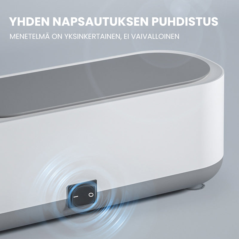 Kompakt hvid-grå ultralyd renser til dybderensning; fjerner snavs fra briller og smykker med højfrekvent vibration