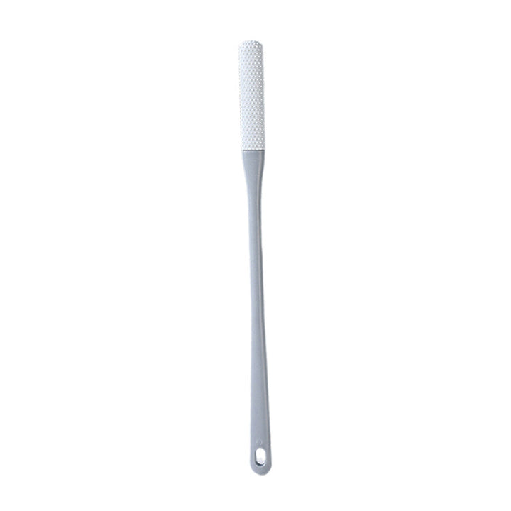 Kompakt tåspalte rensebørste, ergonomisk håndtag, bløde børster, ideel til fodhygiejne.