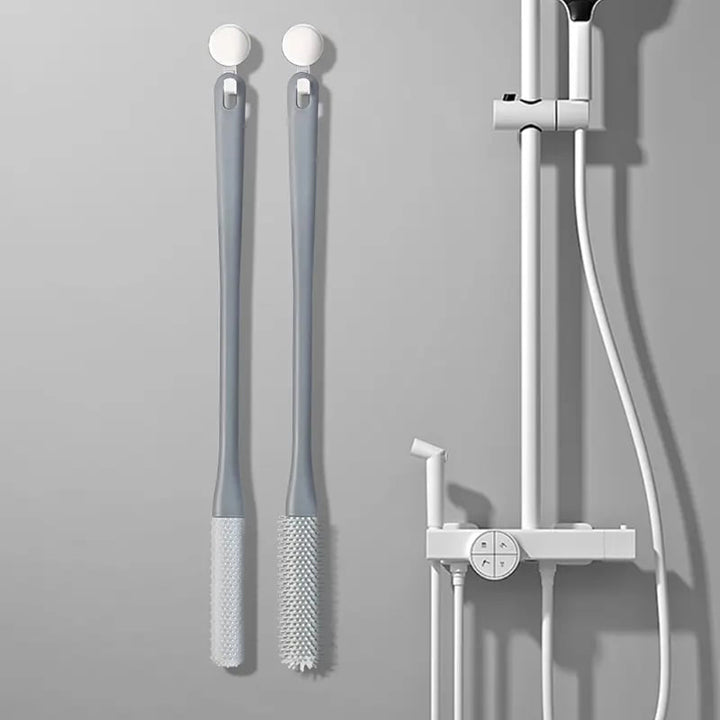 Kompakt tåspalte rensebørste, ergonomisk håndtag, bløde børster, ideel til fodhygiejne.
