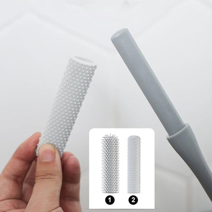 Kompakt tåspalte rensebørste, ergonomisk håndtag, bløde børster, ideel til fodhygiejne.