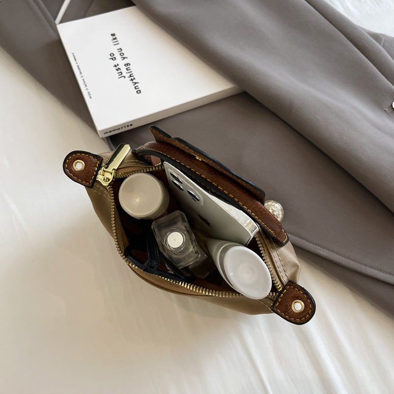 Kompakt farveblok crossbody-taske til damer i nuancer af blå, sort og khaki; en praktisk og stilfuld accessory.