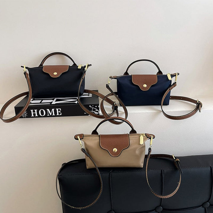 Kompakt farveblok crossbody-taske til damer i nuancer af blå, sort og khaki; en praktisk og stilfuld accessory.