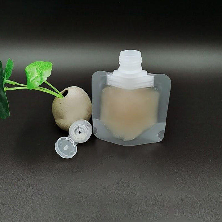 Gennemsigtig 100 ml pose til kosmetik, tæt skruelåg, genopfyldelig, praktisk design.