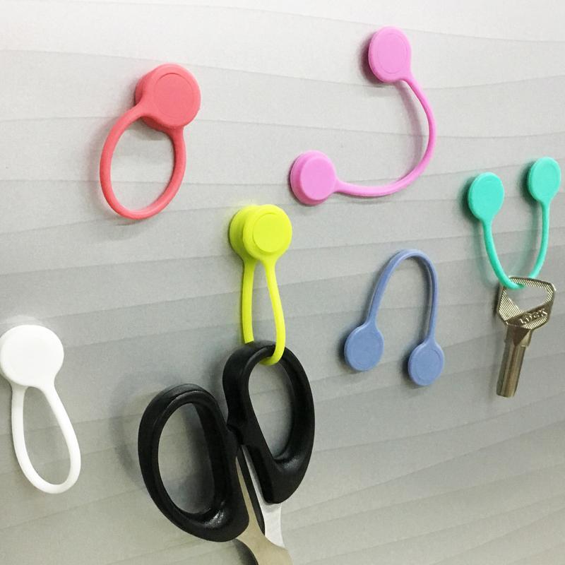 Magneettiset kaapelisiteet: värikkäät silikonipidikkeet, minimalistinen muotoilu, vahva magneettikiinnitys.