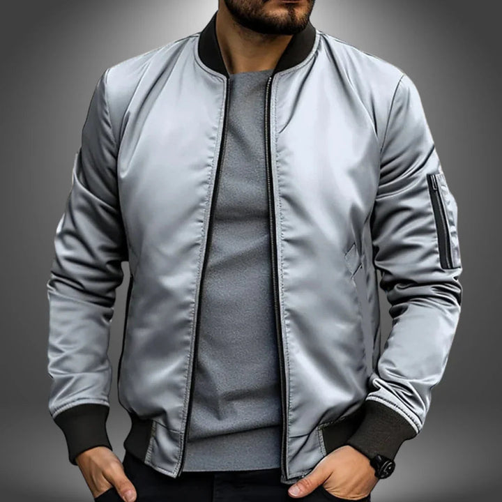 "Miesten kevyt tuulitakkityylinen bomber-takki, minimalistinen design, ribbaus hihansuissa, vetoketjullinen tasku"