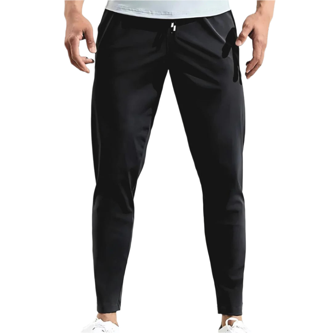 Miesten tapered fit juoksuhousut, kosteutta siirtävä materiaali, joustava vyötärö, moderni leikkaus, vetoketjulliset taskut.