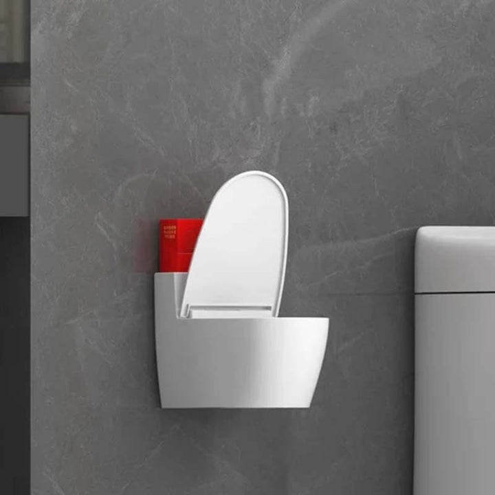 Moderne sølv-guld-hvid toilet askebæger, der ligner et miniaturetoilet, lavet af holdbart ABS-plast.