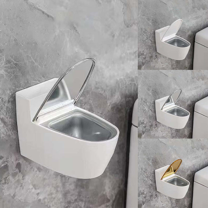 Moderne sølv-guld-hvid toilet askebæger, der ligner et miniaturetoilet, lavet af holdbart ABS-plast.