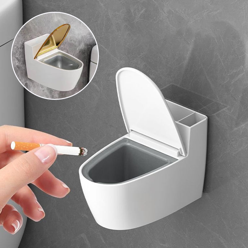 Moderne sølv-guld-hvid toilet askebæger, der ligner et miniaturetoilet, lavet af holdbart ABS-plast.