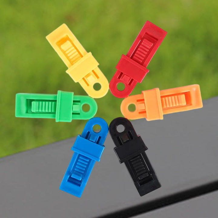 Multifunktionelle tarp clips til udendørs brug, sorte, savtakket klemme, strømlinet design, holdbar PA-plastik.