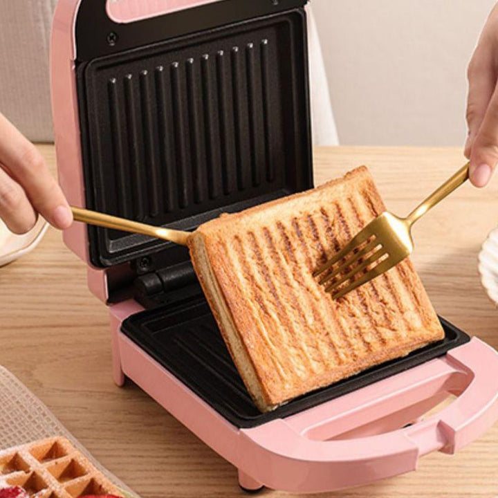 Multifarvet dobbelt smørrebrødgrill, lyserød, rød og grøn, køkkenredskab, kompakt og moderne design.