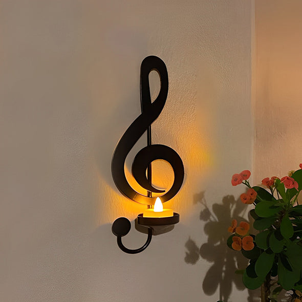 Musiikkiaiheinen musta metallinen seinävalaisin, jossa diskanttiavain ja nuottisymbolit, sopii moderniin sisustukseen ja antaa elegantin ilmeen.