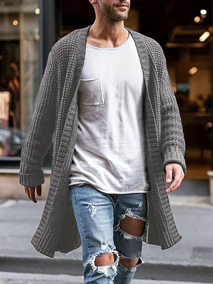 "Musta miesten klassinen neuletakki, pyöreä pääntie ja painikekki, elegantti ja ajaton design. Täydellinen tyylikkyys."