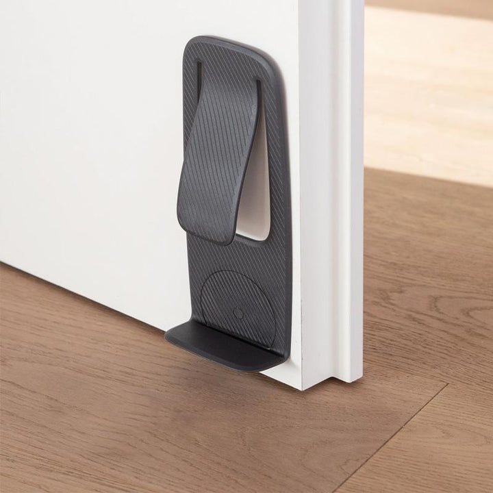 Sort dørstopper, kompakt og praktisk design, velegnet til alle overflader, øger dit hjems sikkerhed.