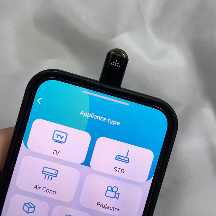 Sort multifunktionel fjernbetjening til smartphones, der styrer de fleste enheder, inklusive silikonecover og nøglering.