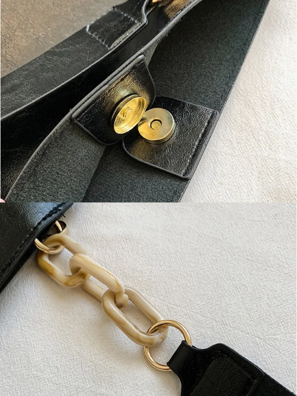 Sort stilfuld skuldertaske til kvinder, tidløst design, rummelig og justerbar skulderrem.