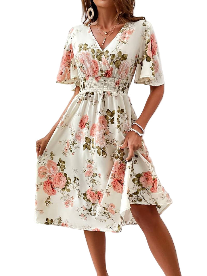 Dame A-formet festkjole med V-hals og blomstertryk, elegant snit og flæseærmer, set bagfra.