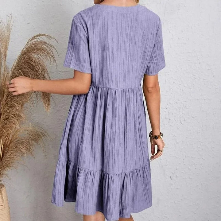 Damekjole med V-hals og peplum, korte ærmer, fit and flare silhuet, let og behagelig.