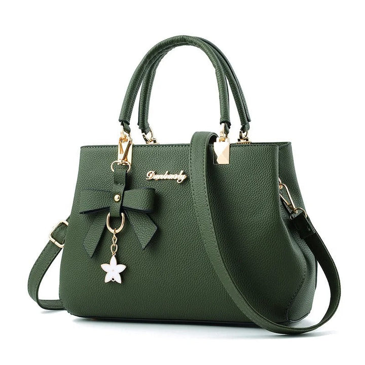 Dame skuldertaske med blomsterhåndtag, struktureret tote-stil, skinnende finish, justerbar rem.