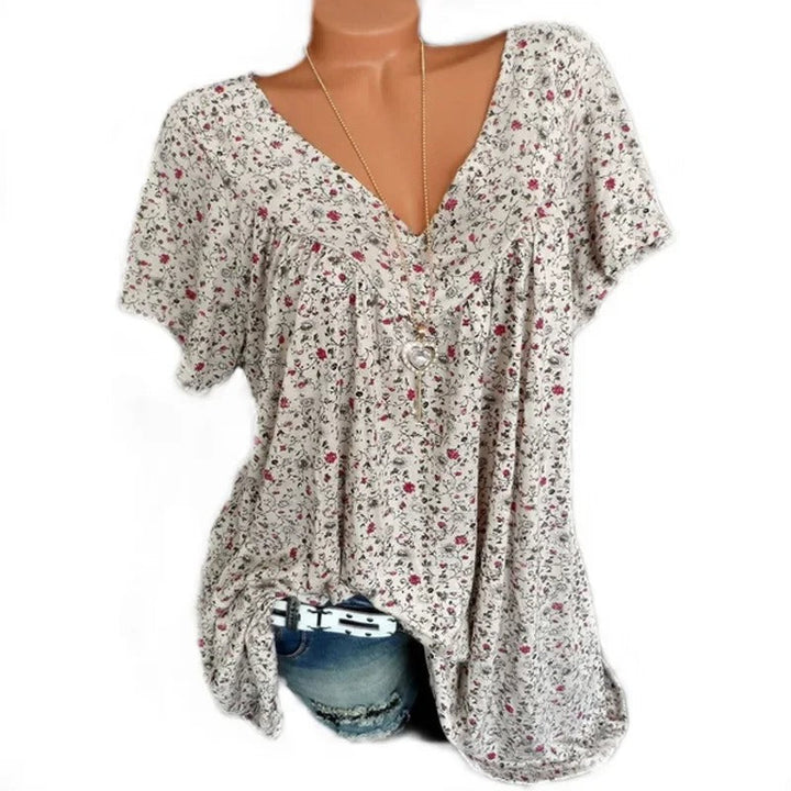 Dame blomstret V-udskåret top, blødt stof, livligt blomstermønster, sommerlig, smigrende snit, ærmeløst design.