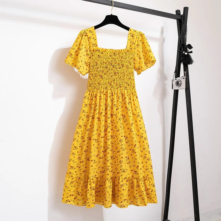 Damekjole med blomsterprint og åben ryg, regnbuens nuancer, let chiffonstof, elastisk talje.
