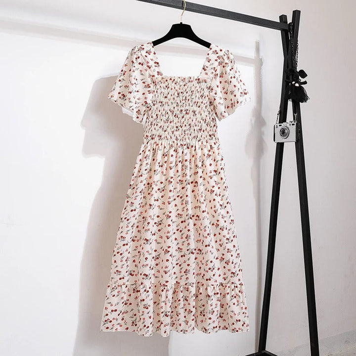 Damekjole med blomsterprint og åben ryg, regnbuens nuancer, let chiffonstof, elastisk talje.